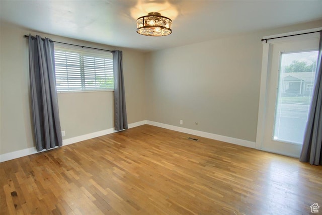 3600 S 6580 W, West Valley City, UT 84128 - empty room featuring plenty of natural light, light wood-type flooring, and baseboards