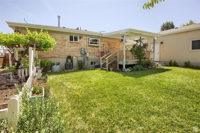 3600 S 6580 W, West Valley City, UT 84128 - back of property with a lawn, brick siding, central AC, and a deck