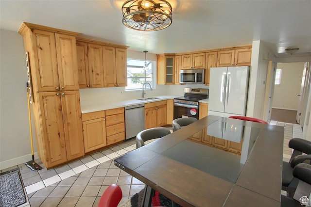 3600 S 6580 W, West Valley City, UT 84128 - kitchen with appliances with stainless steel finishes, a sink, light tile patterned floors, and light brown cabinetry