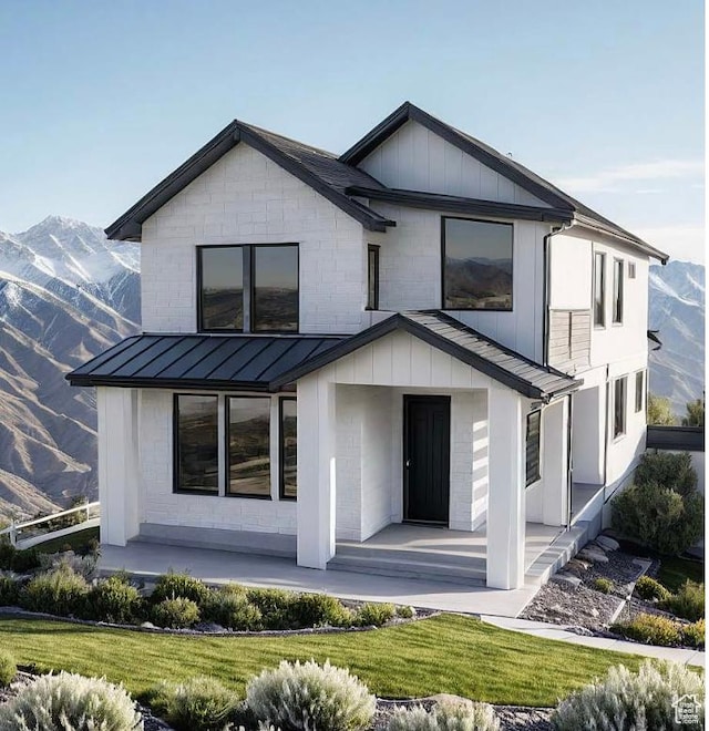 10733 N Dosh Ln Unit 12, Highland, UT 84003 - rear view of house with a standing seam roof, covered porch, a mountain view, and metal roof