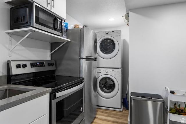 480 S 1160 W, Orem, UT 84058 - laundry area featuring stacked washer / drying machine and light wood-type flooring