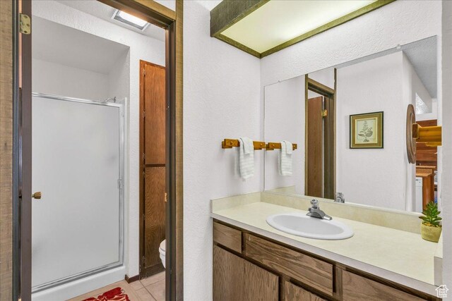 407 S Vasels Rd Unit 27, Brian Head, UT 84719 - full bathroom with a stall shower, vanity, toilet, and tile patterned flooring