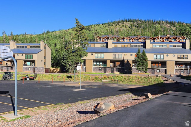 407 S Vasels Rd Unit 27, Brian Head, UT 84719 - view of building exterior featuring uncovered parking and a view of trees