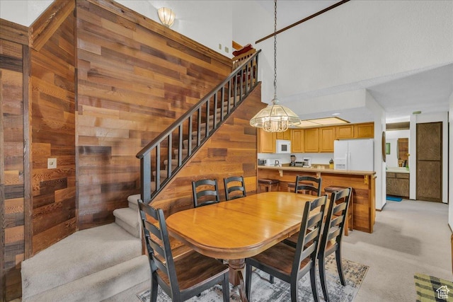 407 S Vasels Rd Unit 27, Brian Head, UT 84719 - dining room featuring stairway, wooden walls, light carpet, and a chandelier