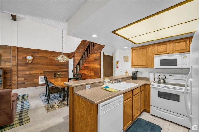 407 S Vasels Rd Unit 27, Brian Head, UT 84719 - kitchen featuring white appliances, a sink, wood walls, a peninsula, and brown cabinets
