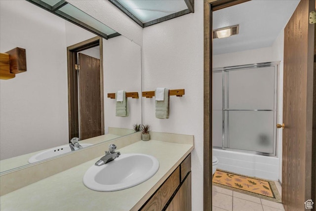 407 S Vasels Rd Unit 27, Brian Head, UT 84719 - full bathroom featuring vanity, toilet, tile patterned floors, and enclosed tub / shower combo
