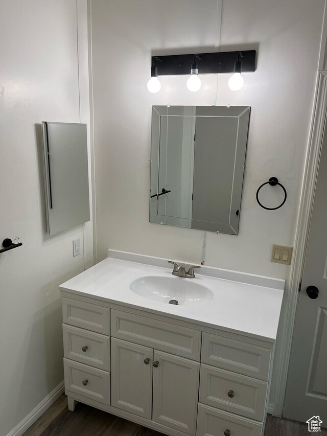 380 W Main, Myton, UT 84052 - bathroom featuring vanity and wood finished floors