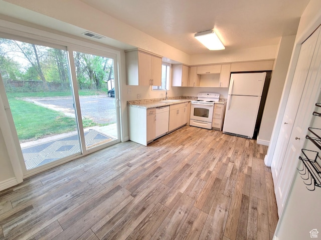 151 E Southwell St N Unit 9, Ogden, UT 84404 - kitchen with white appliances, light wood finished floors, light countertops, a sink, and baseboards
