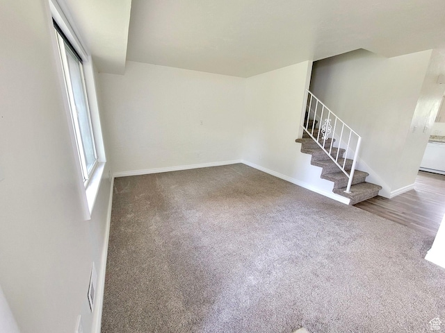 151 E Southwell St N Unit 9, Ogden, UT 84404 - unfurnished living room with carpet, stairs, and baseboards