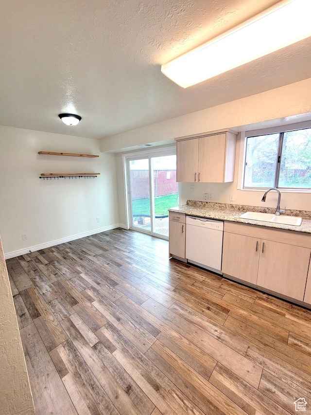 151 E Southwell St N Unit 9, Ogden, UT 84404 - kitchen featuring white dishwasher, a sink, light wood-style floors, light brown cabinets, and a textured ceiling