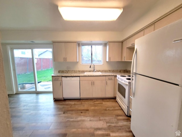 151 E Southwell St N Unit 9, Ogden, UT 84404 - kitchen featuring white appliances, a sink, light countertops, and light wood-style floors