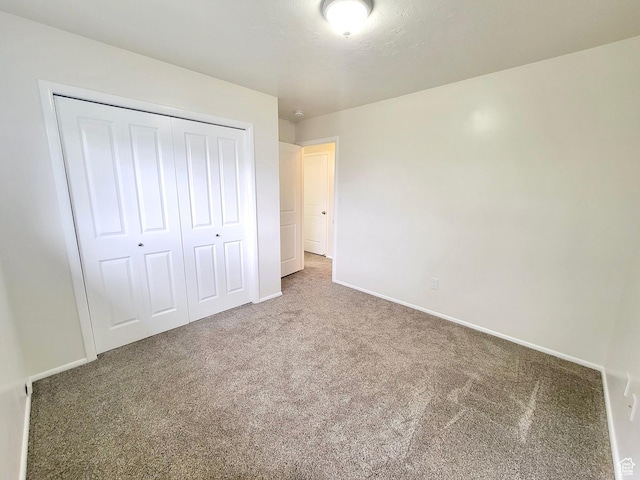 151 E Southwell St N Unit 9, Ogden, UT 84404 - unfurnished bedroom with carpet flooring, a closet, and baseboards