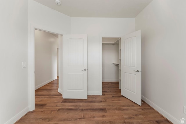 4236 N 2375 W, Cedar City, UT 84721 - unfurnished bedroom featuring wood finished floors, baseboards, and a walk in closet