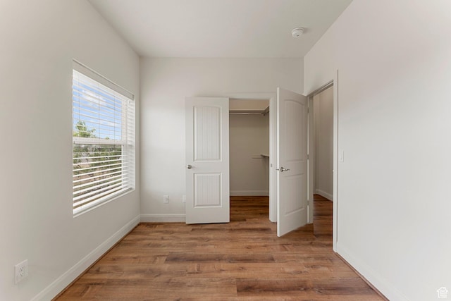 4236 N 2375 W, Cedar City, UT 84721 - unfurnished bedroom with light wood finished floors, baseboards, a walk in closet, and a closet