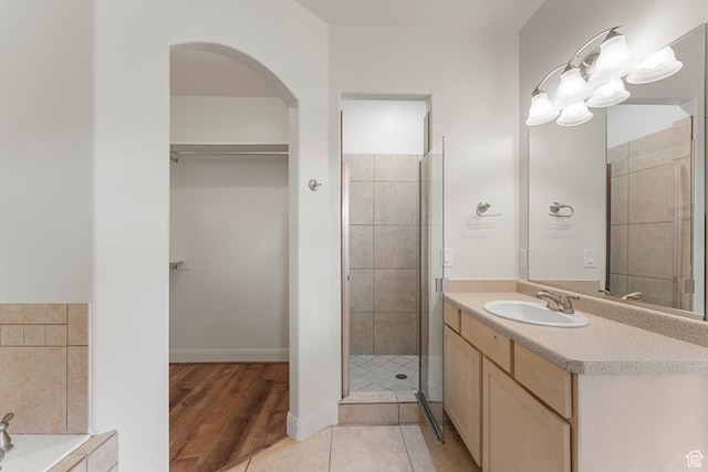 4236 N 2375 W, Cedar City, UT 84721 - bathroom with vanity, a spacious closet, a stall shower, wood finished floors, and a tub to relax in