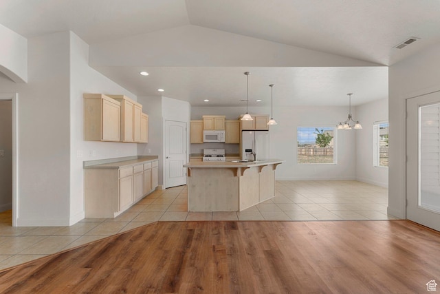 4236 N 2375 W, Cedar City, UT 84721 - kitchen featuring white appliances, light brown cabinetry, lofted ceiling, light tile patterned flooring, and light countertops