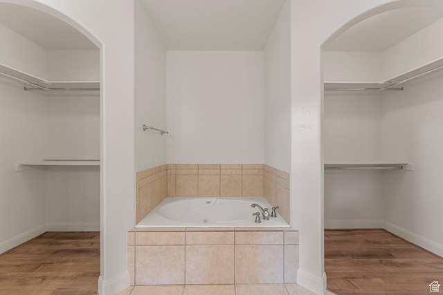 4236 N 2375 W, Cedar City, UT 84721 - bathroom featuring a jetted tub, a spacious closet, and wood finished floors