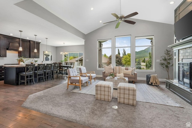 6035 Hidden Valley Rd, Mountain Green, UT 84050 - living room with high vaulted ceiling, recessed lighting, a ceiling fan, a glass covered fireplace, and wood finished floors