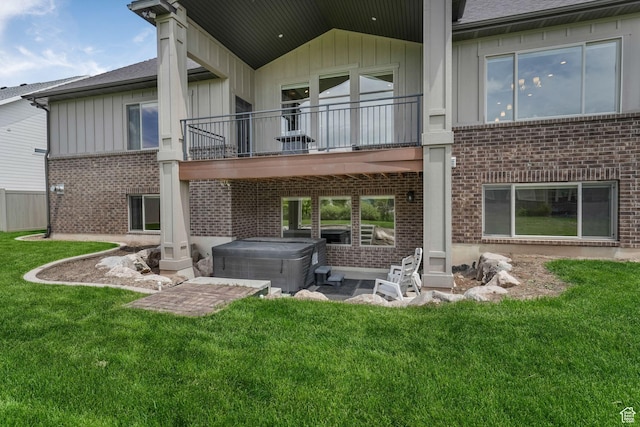 6035 Hidden Valley Rd, Mountain Green, UT 84050 - back of property with a hot tub, brick siding, a balcony, a lawn, and board and batten siding