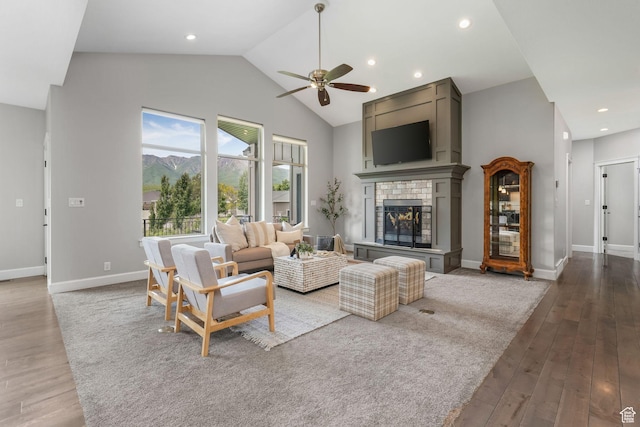 6035 Hidden Valley Rd, Mountain Green, UT 84050 - living room featuring high vaulted ceiling, ceiling fan, wood finished floors, a fireplace, and baseboards