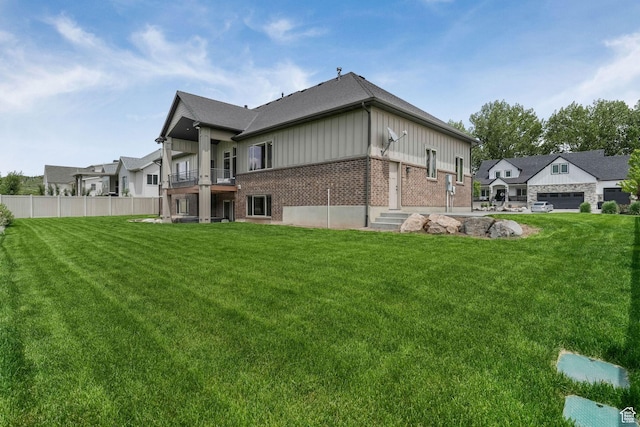 6035 Hidden Valley Rd, Mountain Green, UT 84050 - back of house with a balcony, board and batten siding, and brick siding