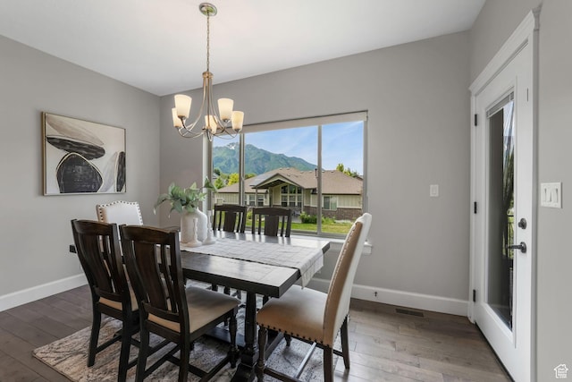 6035 Hidden Valley Rd, Mountain Green, UT 84050 - dining room with a chandelier, baseboards, wood finished floors, and a mountain view