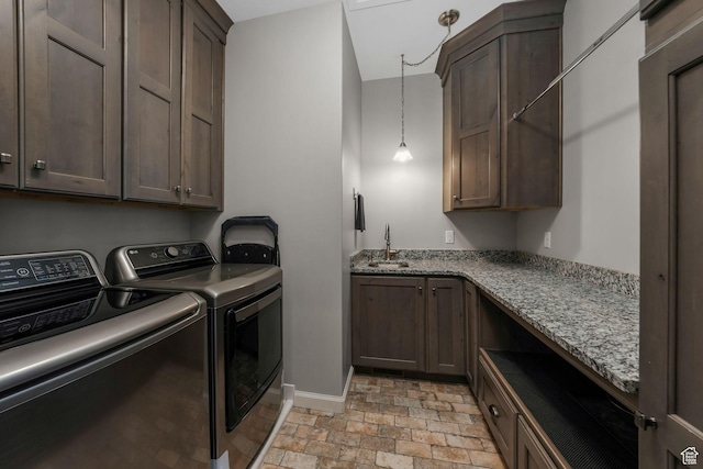 6035 Hidden Valley Rd, Mountain Green, UT 84050 - laundry area with independent washer and dryer, cabinet space, baseboards, and light stone finish floors