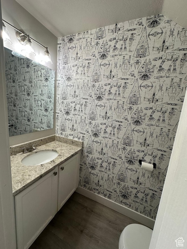39 W 1930 N, Tooele, UT 84074 - bathroom featuring wood finished floors, vanity, toilet, and baseboards