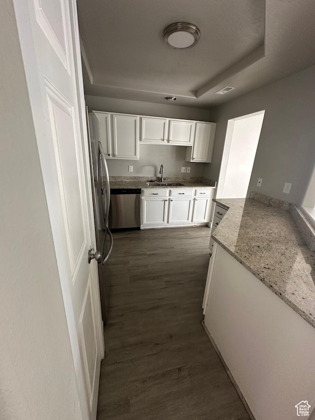 39 W 1930 N, Tooele, UT 84074 - kitchen featuring stainless steel appliances, white cabinets, a sink, dark wood finished floors, and light stone countertops