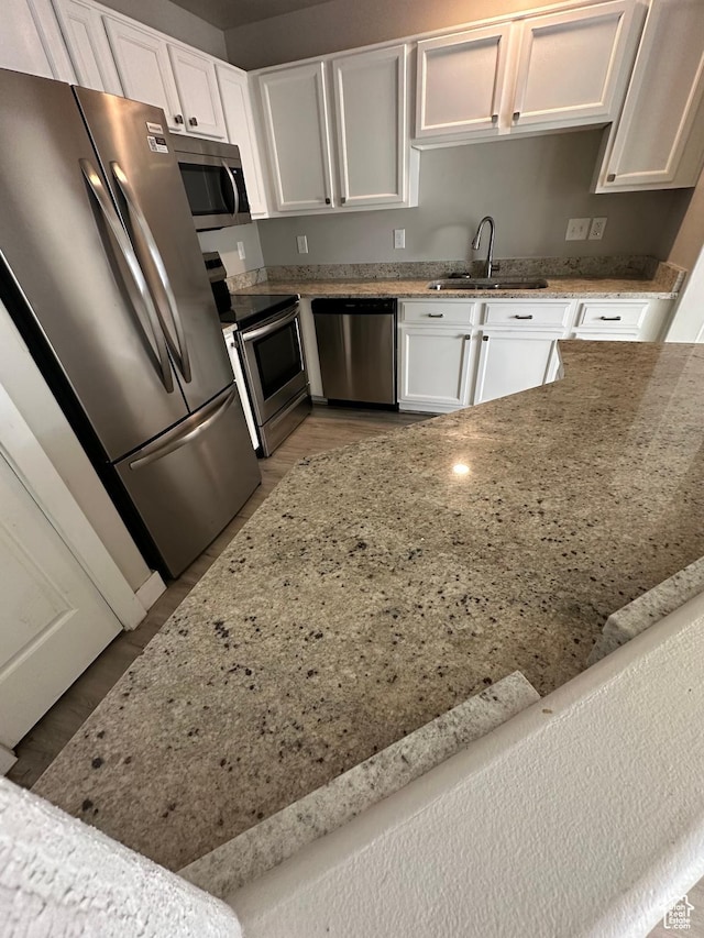 39 W 1930 N, Tooele, UT 84074 - kitchen featuring stainless steel appliances, a sink, white cabinetry, and light stone counters