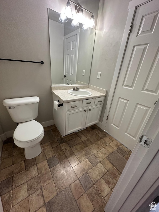 39 W 1930 N, Tooele, UT 84074 - half bath with stone tile flooring, vanity, toilet, and baseboards