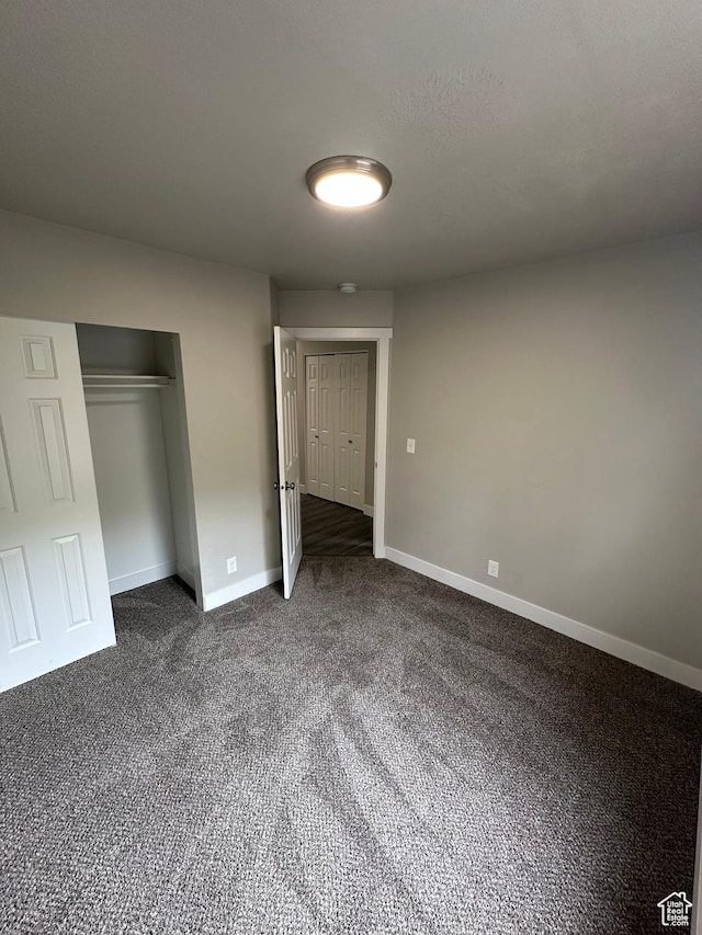 39 W 1930 N, Tooele, UT 84074 - unfurnished bedroom with baseboards, dark colored carpet, and a closet