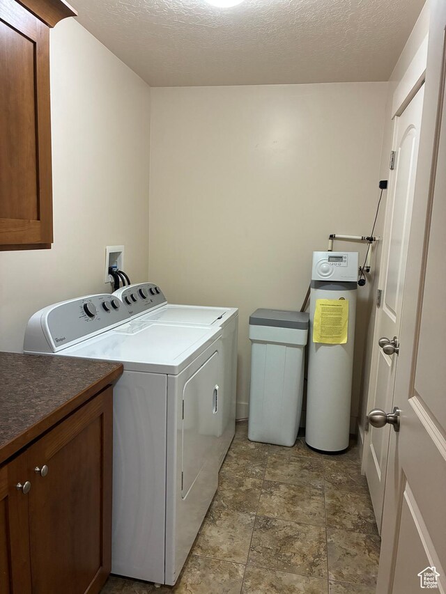 1045 S 1700 W Unit 912, Payson, UT 84651 - washroom with separate washer and dryer, stone finish floors, cabinet space, and a textured ceiling