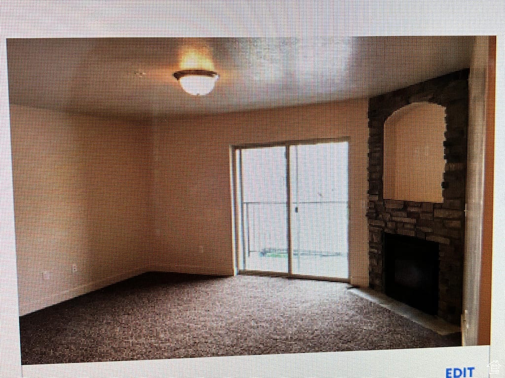 1045 S 1700 W Unit 912, Payson, UT 84651 - unfurnished living room with carpet and a stone fireplace