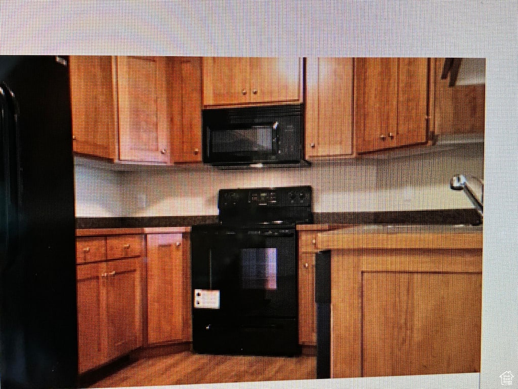 1045 S 1700 W Unit 912, Payson, UT 84651 - kitchen with electric range, dark countertops, decorative backsplash, and brown cabinets