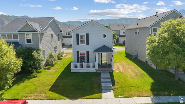 1722 N 80 E, Tooele, UT 84074 - view of front of home featuring cooling unit, a front yard, and a mountain view