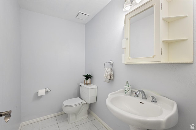 10865 S Granite Dr, Sandy, UT 84094 - half bathroom featuring a sink, toilet, baseboards, and tile patterned flooring