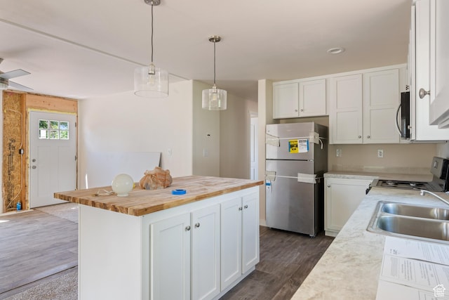 30 N 100 W, Parowan, UT 84761 - kitchen with freestanding refrigerator, stove, butcher block counters, a sink, and white cabinetry