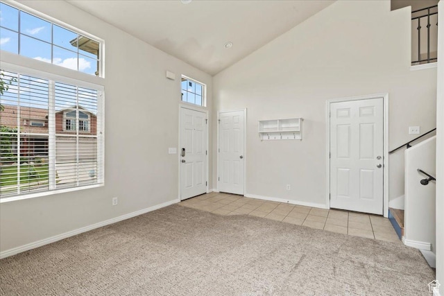 2167 E Eagle Chase Dr, Draper Ut Cnty, UT 84020 - entrance foyer featuring light colored carpet, high vaulted ceiling, light tile patterned floors, and baseboards