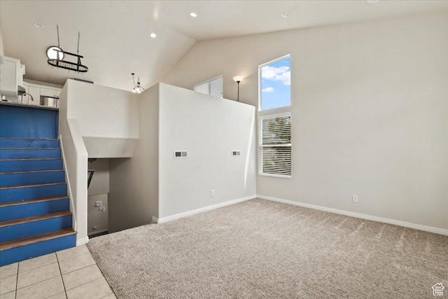 2167 E Eagle Chase Dr, Draper Ut Cnty, UT 84020 - spare room featuring stairs, baseboards, light colored carpet, high vaulted ceiling, and light tile patterned floors