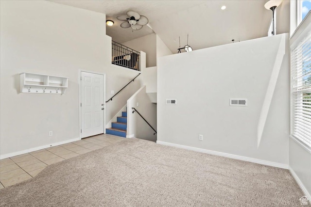 2167 E Eagle Chase Dr, Draper Ut Cnty, UT 84020 - carpeted spare room featuring tile patterned flooring, a high ceiling, baseboards, and stairway