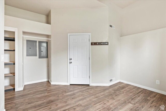 2167 E Eagle Chase Dr, Draper Ut Cnty, UT 84020 - spare room featuring electric panel, wood finished floors, baseboards, and a towering ceiling