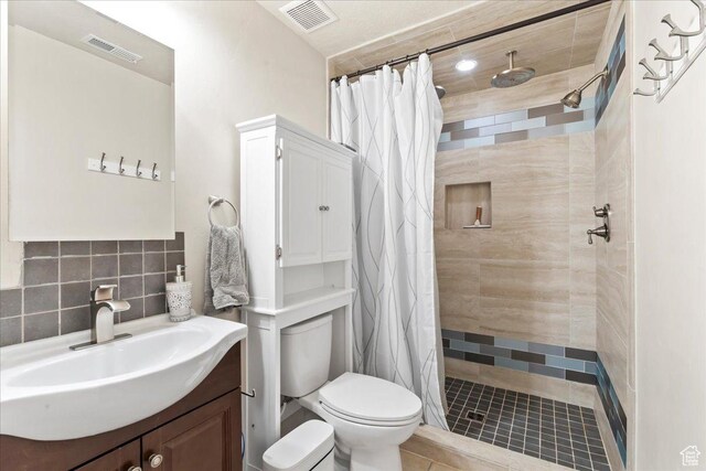 2167 E Eagle Chase Dr, Draper Ut Cnty, UT 84020 - bathroom with vanity, toilet, a tile shower, and tile patterned flooring