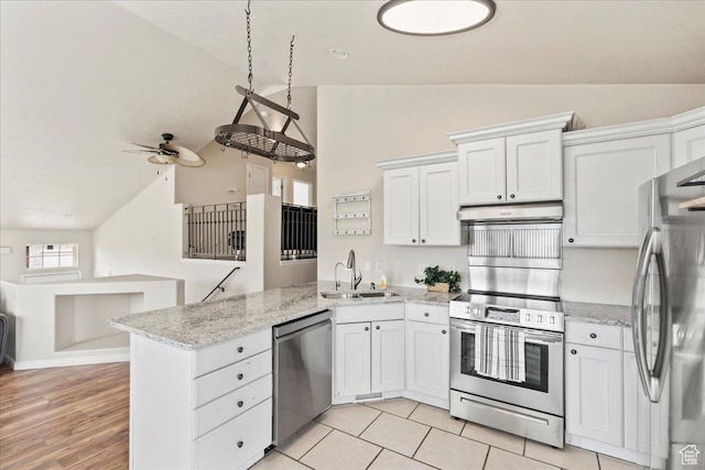 2167 E Eagle Chase Dr, Draper Ut Cnty, UT 84020 - kitchen featuring stainless steel appliances, vaulted ceiling, a sink, a peninsula, and white cabinets