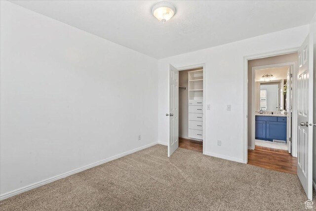 2167 E Eagle Chase Dr, Draper Ut Cnty, UT 84020 - unfurnished bedroom featuring carpet flooring, baseboards, a walk in closet, and a closet