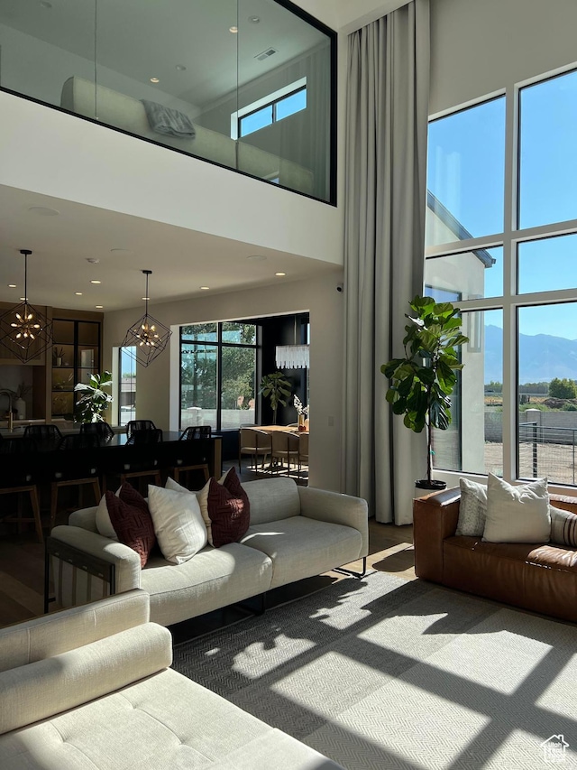 9671 N Belle St Unit 813, Eagle Mountain, UT 84005 - living room featuring a chandelier, a high ceiling, and a mountain view