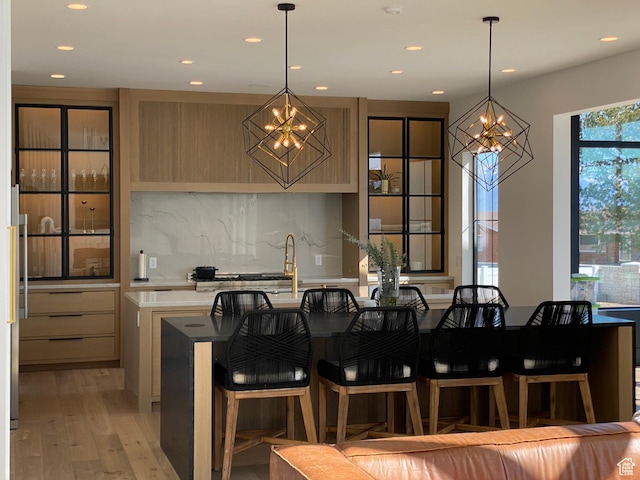 9671 N Belle St Unit 813, Eagle Mountain, UT 84005 - kitchen with a chandelier, recessed lighting, light countertops, backsplash, and light wood finished floors
