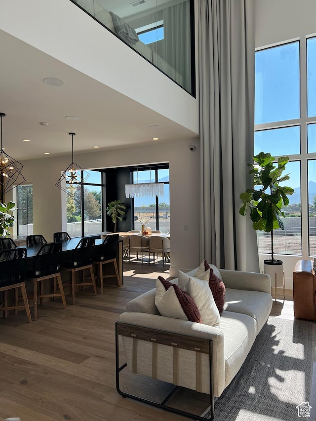 9671 N Belle St Unit 813, Eagle Mountain, UT 84005 - living room with wood finished floors, a chandelier, and a high ceiling