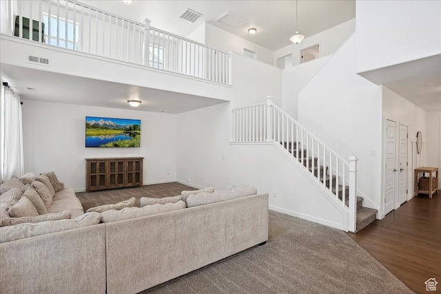 3278 S Boots Way, Syracuse, UT 84075 - living area with stairs, a towering ceiling, baseboards, and wood finished floors