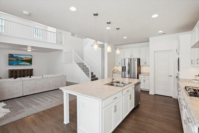 3278 S Boots Way, Syracuse, UT 84075 - kitchen with appliances with stainless steel finishes, a sink, light countertops, open floor plan, and a breakfast bar area